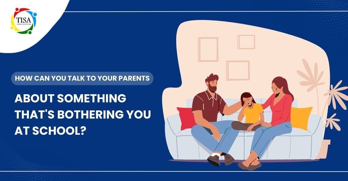 "Illustration of a child sitting between two parents on a couch, with comforting gestures, accompanied by the text 'How can you talk to your parents about something that's bothering you at school?' and the TISA logo in the top left corner."