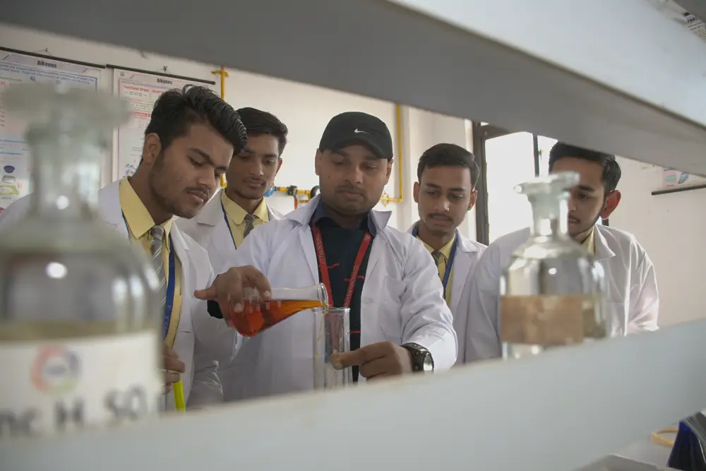 Chemistry teacher at tisa, the best school in agra, guiding students during a hands-on lab experiment.